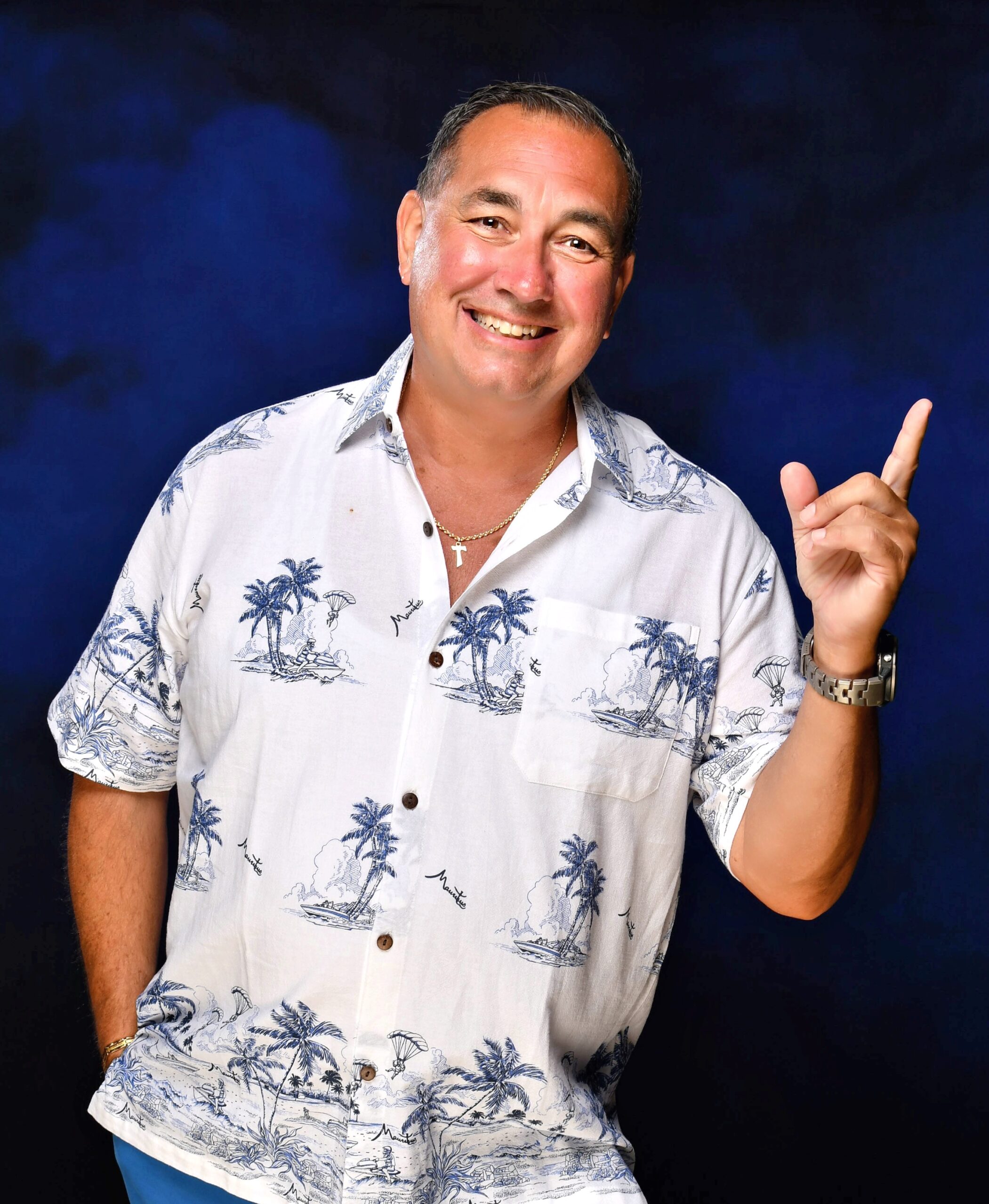 Captain Bill Moore, owner of LivBlue, smiling in a tropical shirt, representing expertise in yacht management, private charters, and boating education.
