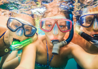 Three snorkelers exploring the crystal-clear waters of the Florida Keys, showcasing the adventure-filled private charters and expert captain services provided by LivBlue.
